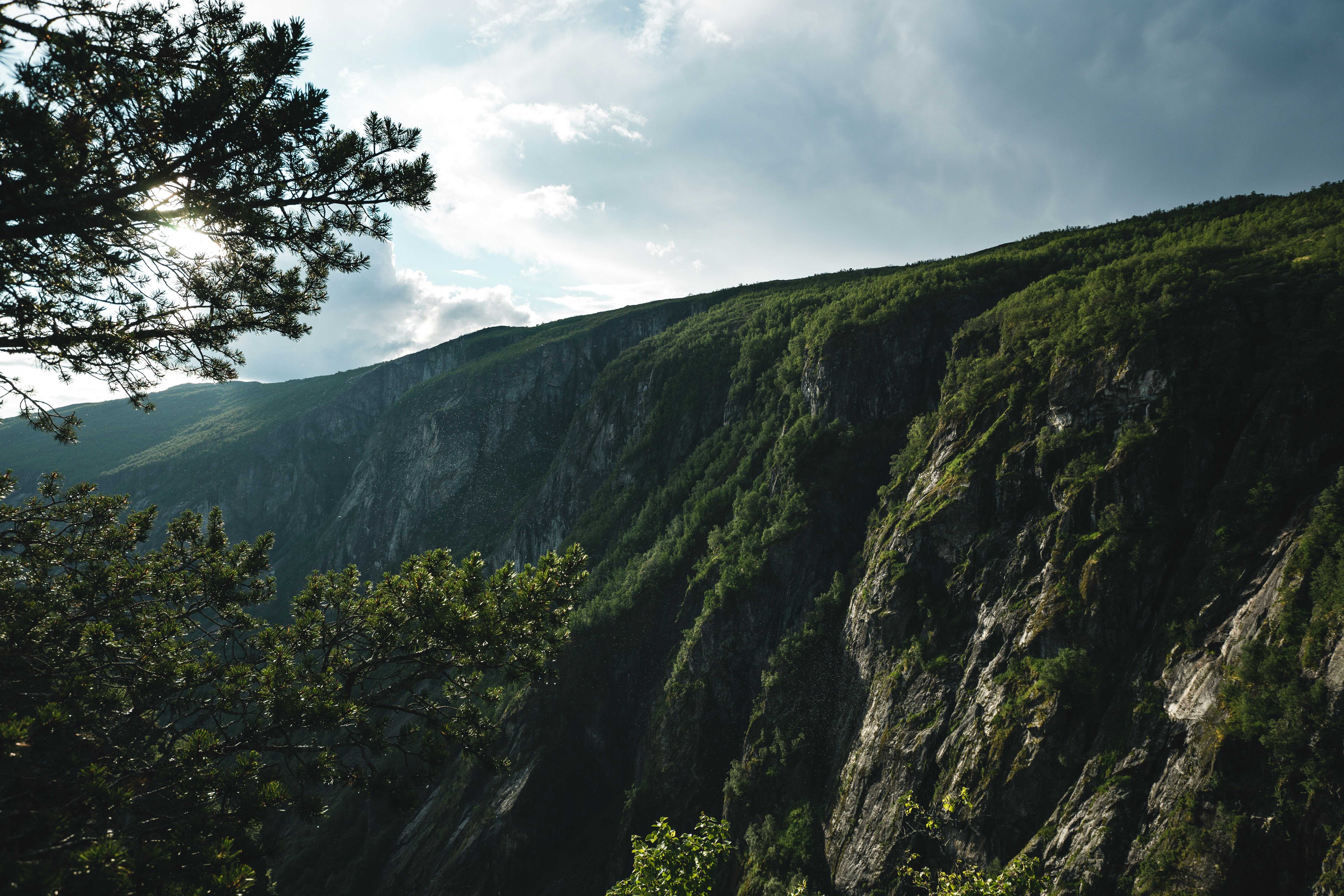 green and gray mountain under white clouds during daytime